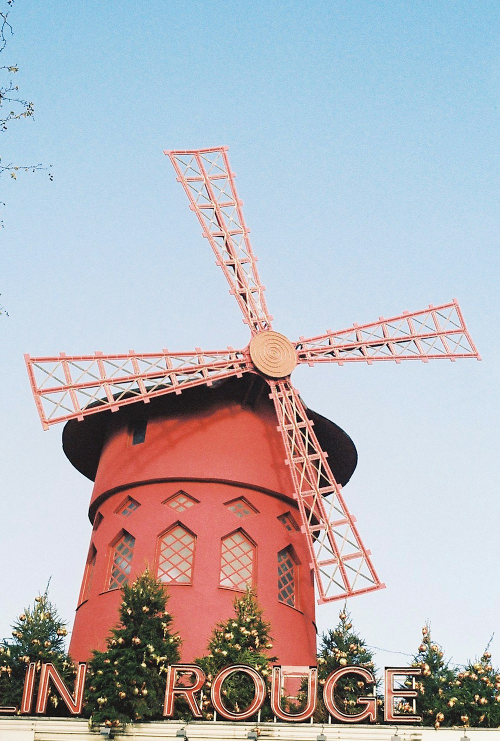 a red building with a windmill on top of it