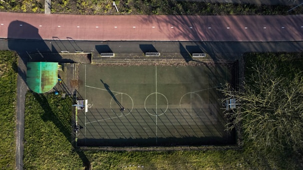 Wide-angle view of a newly constructed outdoor sports court with clear markings and equipment
