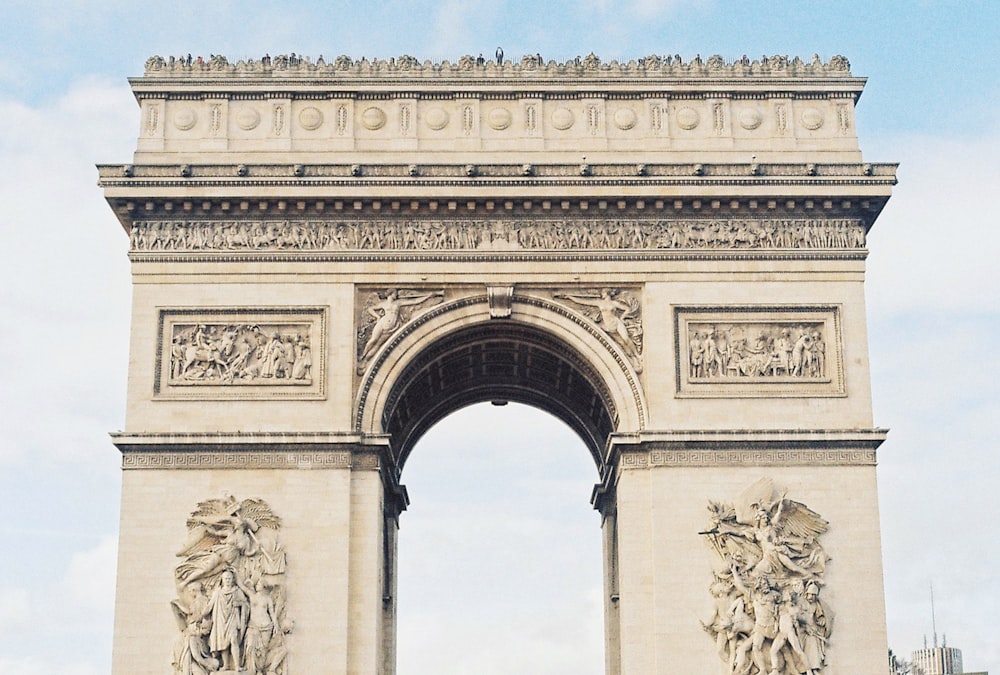 a large stone arch with statues on it