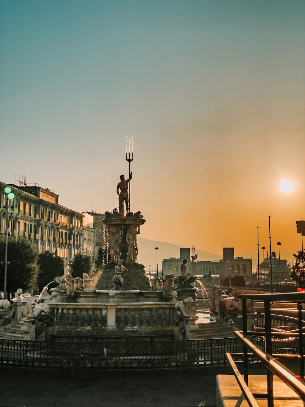 a fountain with a statue of a man on top of it