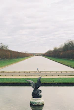 a statue of a bird on top of a fountain