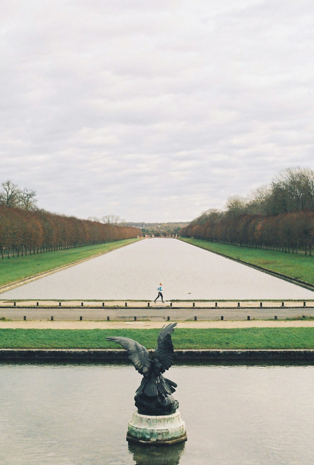 a statue of a bird on top of a fountain