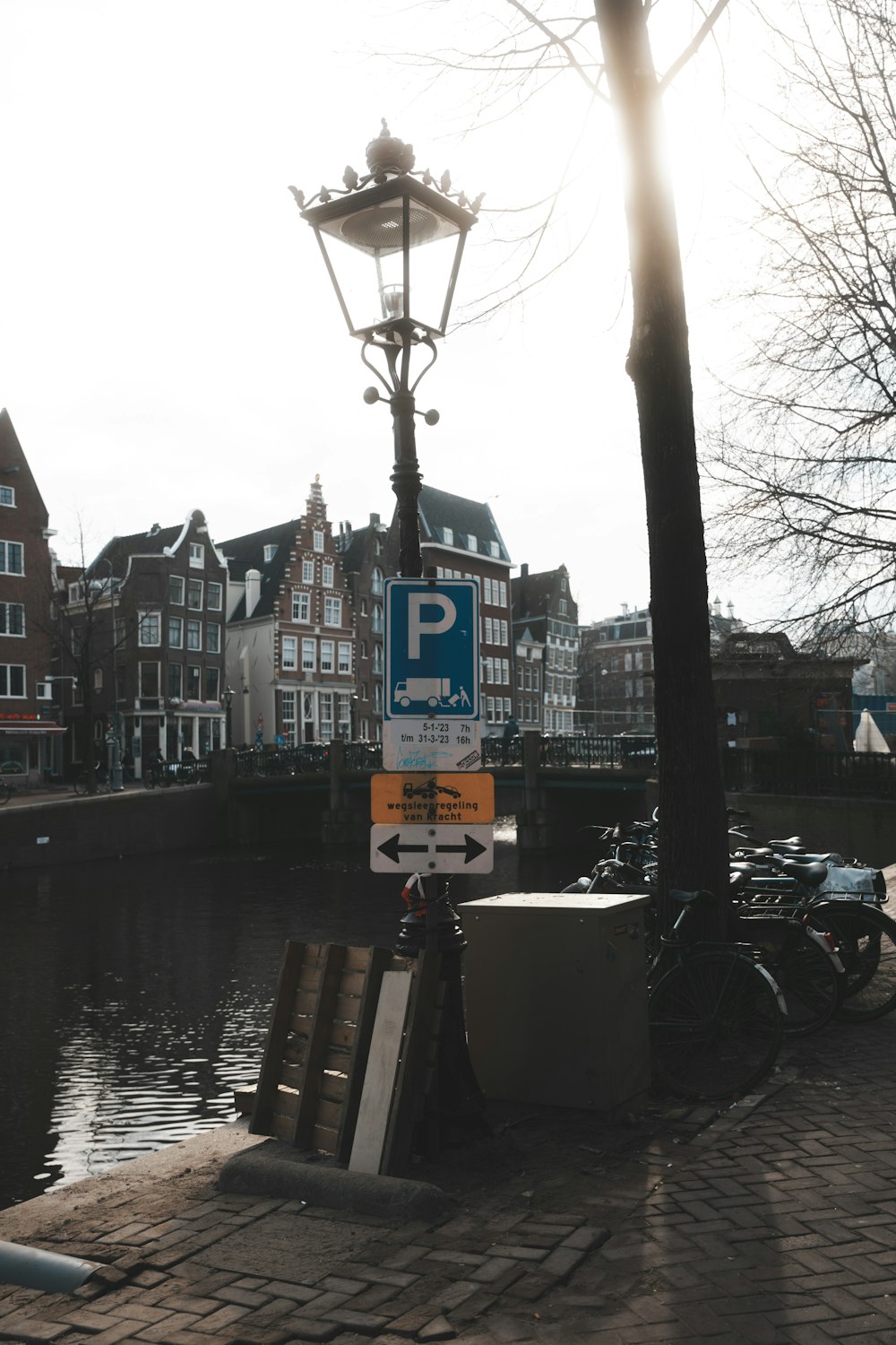 a street sign sitting on the side of a river