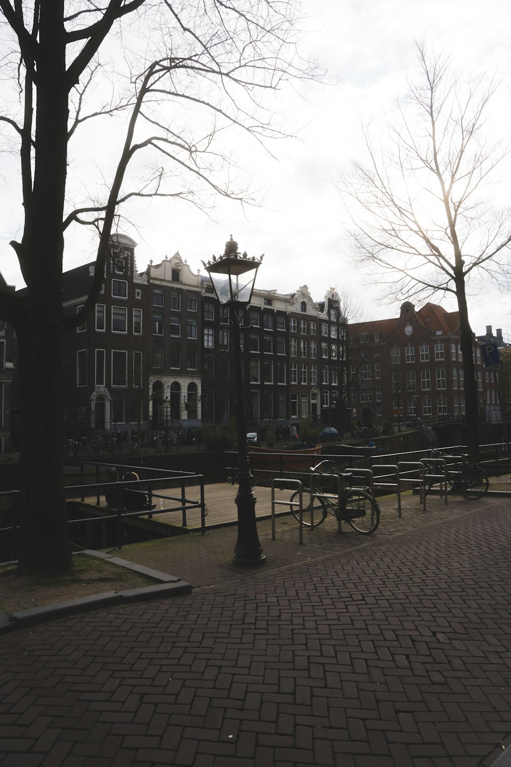 a brick walkway in front of a row of buildings