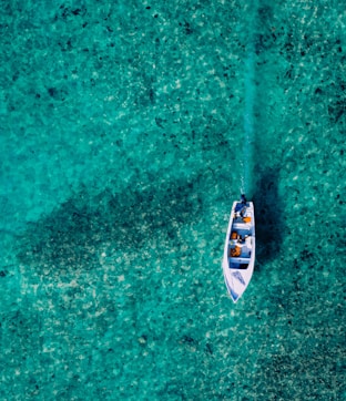 a small boat floating on top of a body of water
