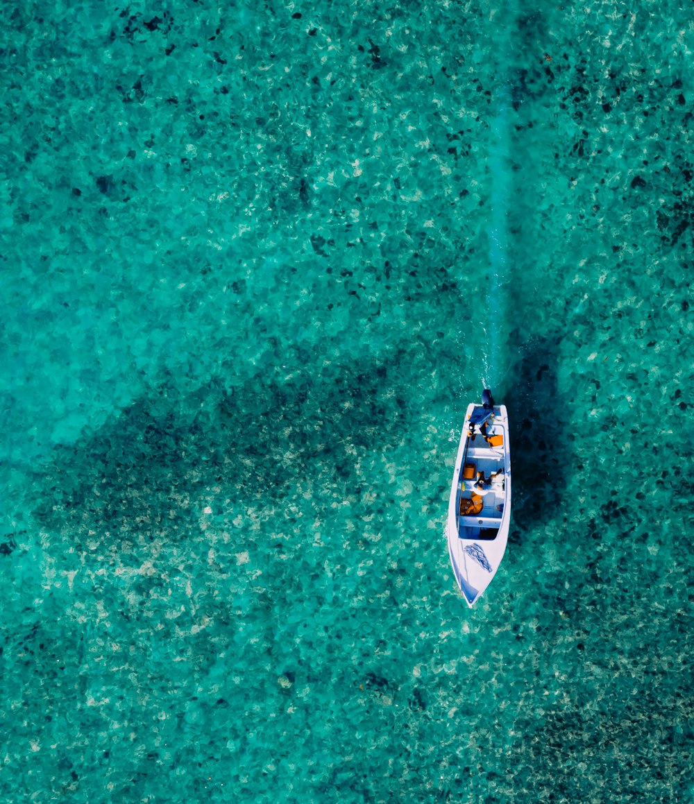 a small boat floating on top of a body of water