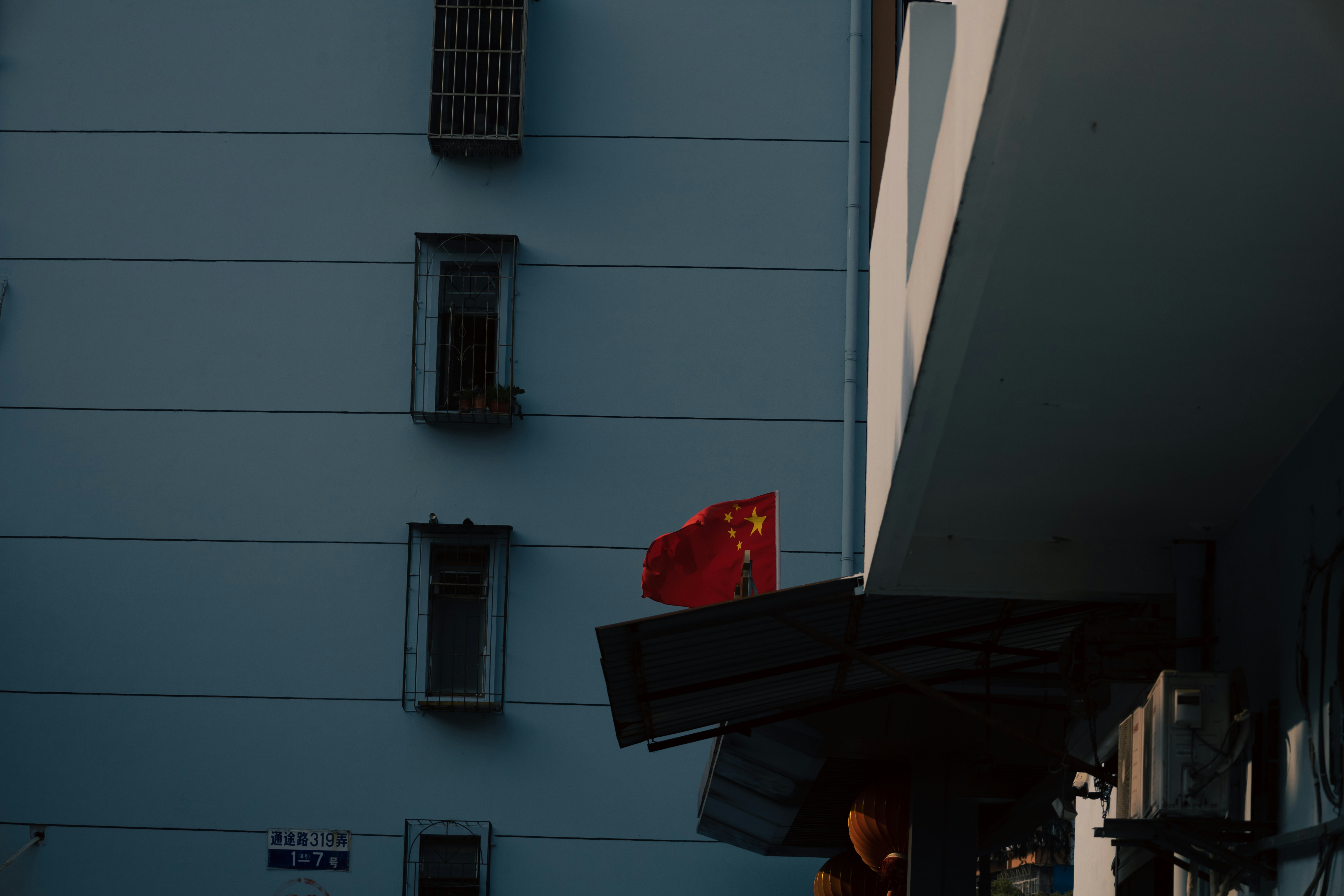 a building with a chinese flag hanging off of it's side