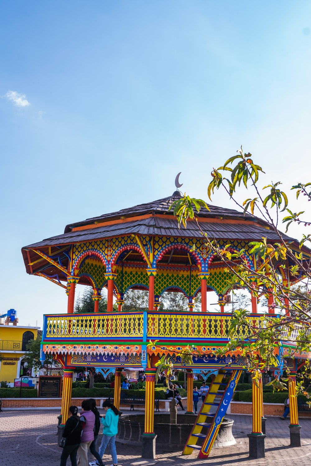 a colorful gazebo with a slide in the middle of it