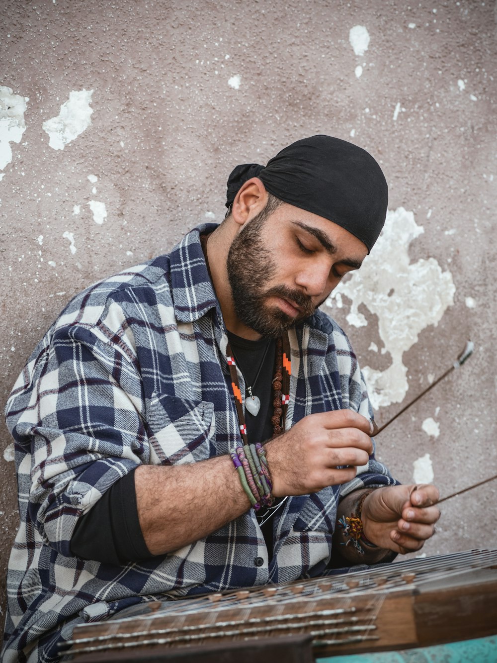 a man sitting on a bench looking at his cell phone