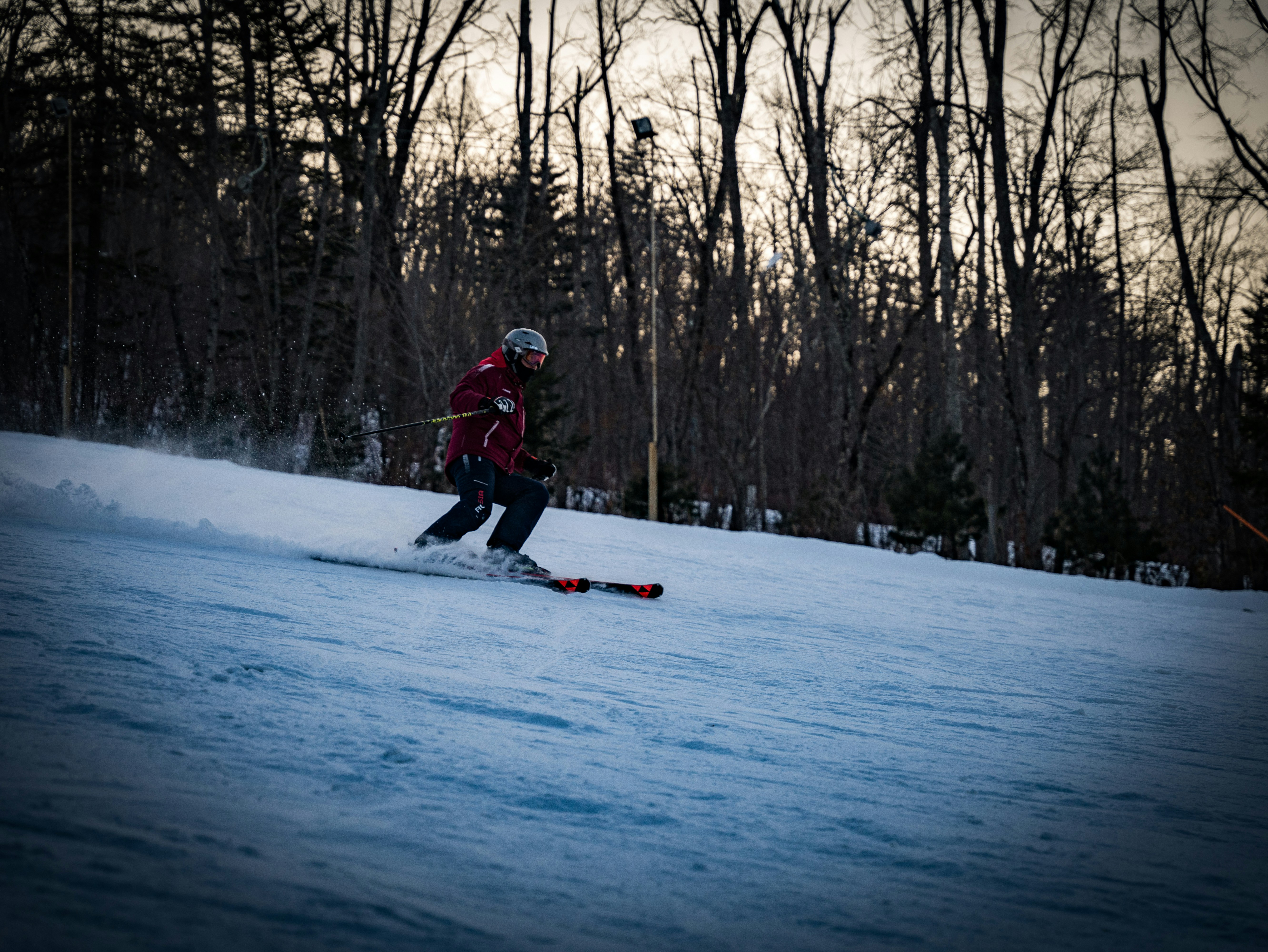 a person riding skis down a snow covered slope, 