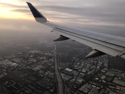 An early morning city skyline viewed from the cockpit of a small plane.