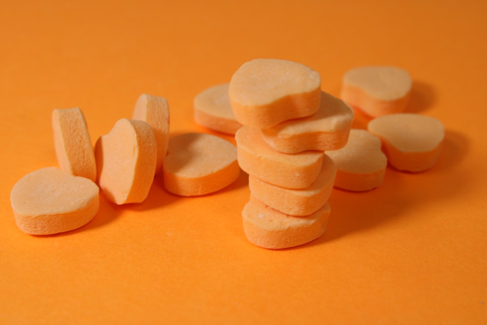a pile of cut up pieces of food on an orange surface
