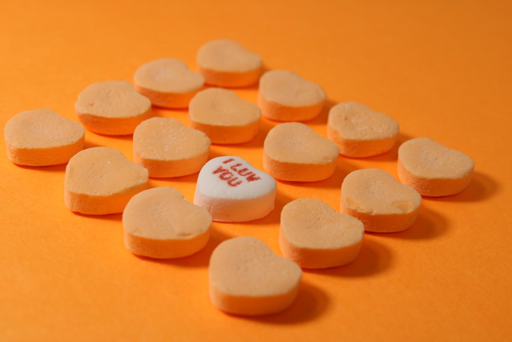 a group of heart shaped candies sitting on top of a table