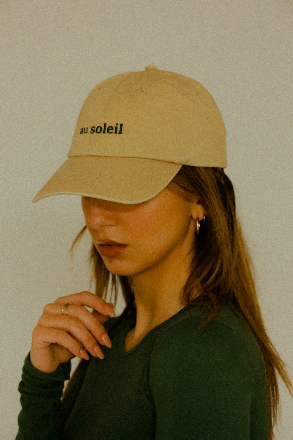 a woman wearing a hat with the word solei on it