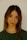 a woman with a green shirt is posing for a picture