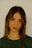 a woman with a green shirt is posing for a picture