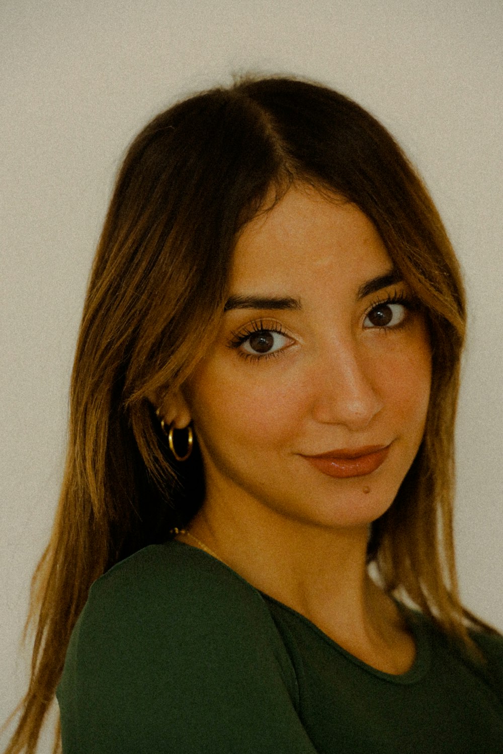 a close up of a person wearing a green shirt