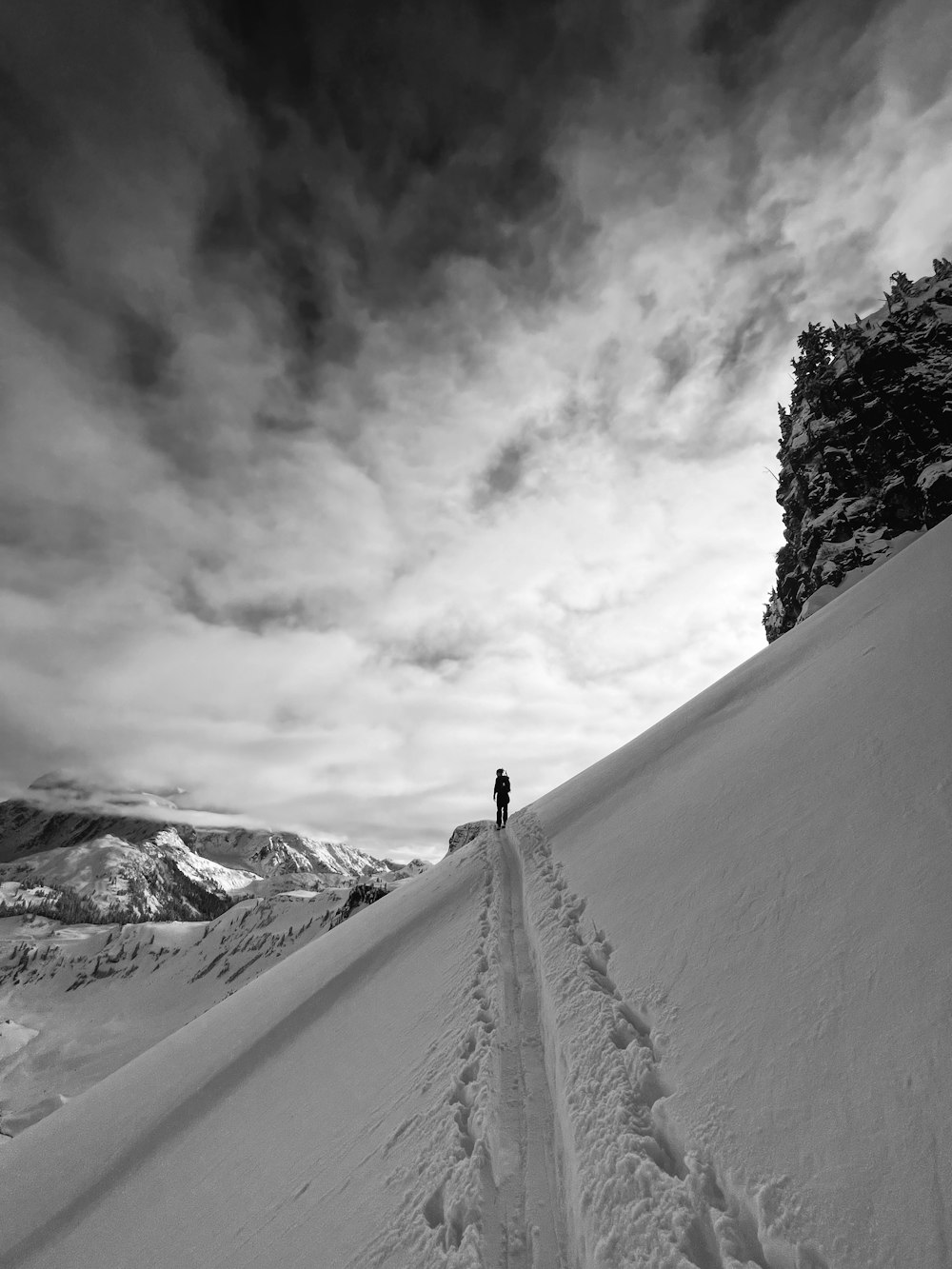 a person standing on top of a snow covered slope