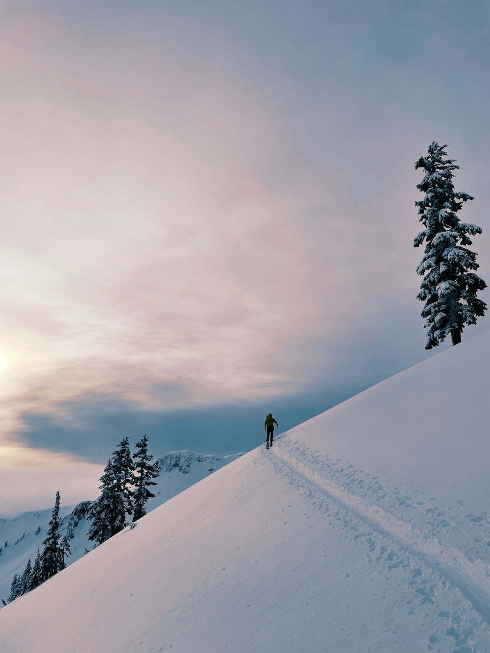 a person standing on top of a snow covered slope