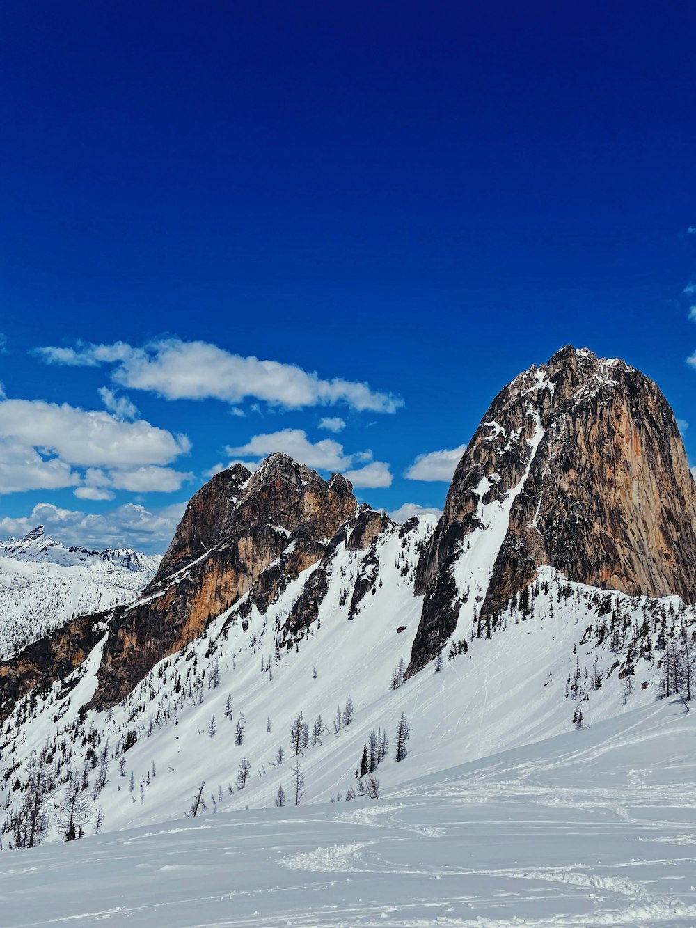 a mountain covered in snow under a blue sky