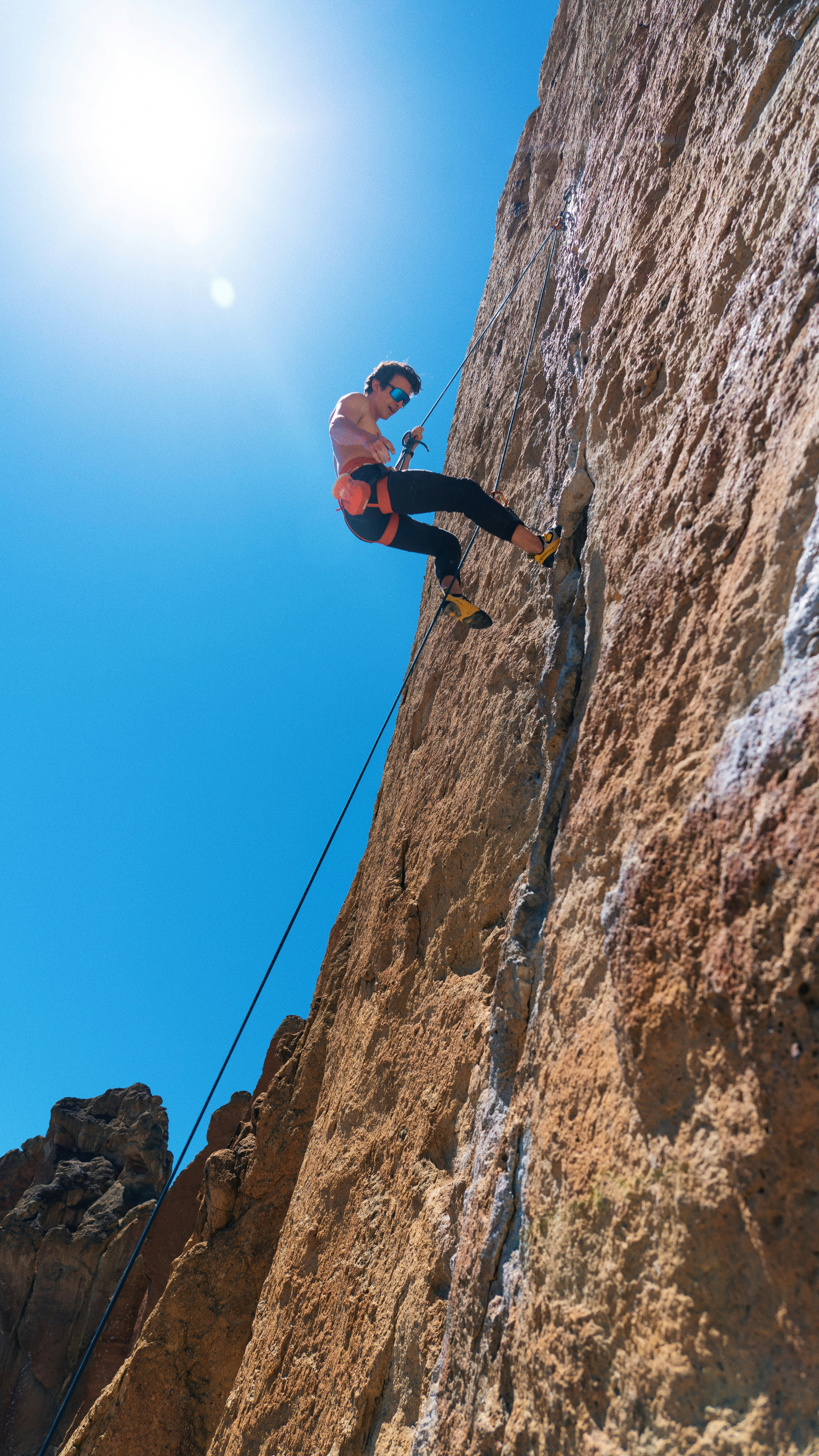 a man climbing up the side of a mountain