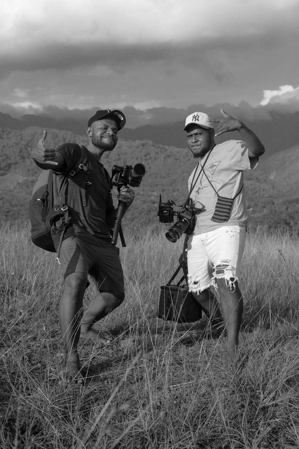 a couple of men standing next to each other in a field