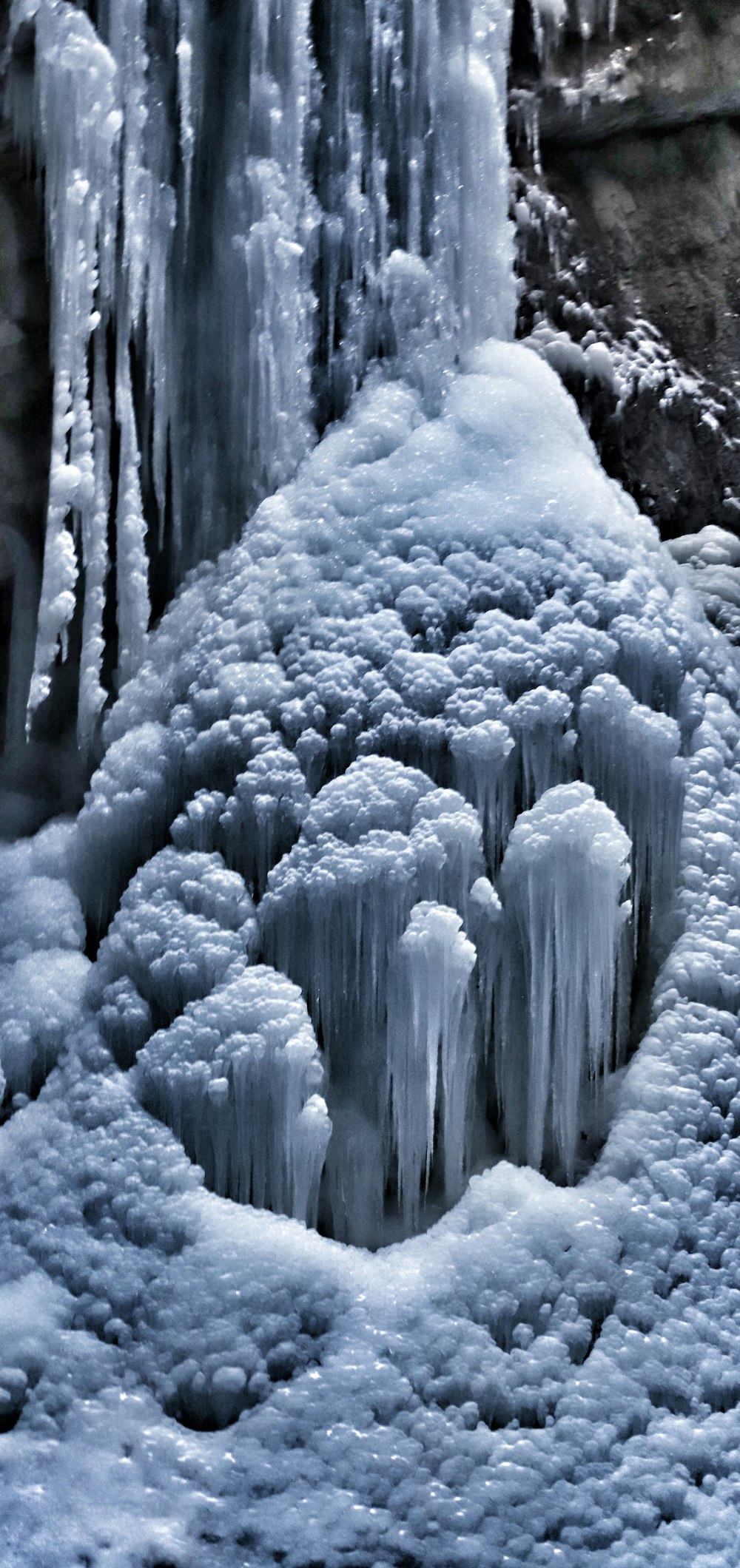 a group of icicles that are next to a waterfall