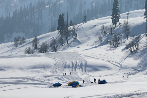 a group of people standing on top of a snow covered slope