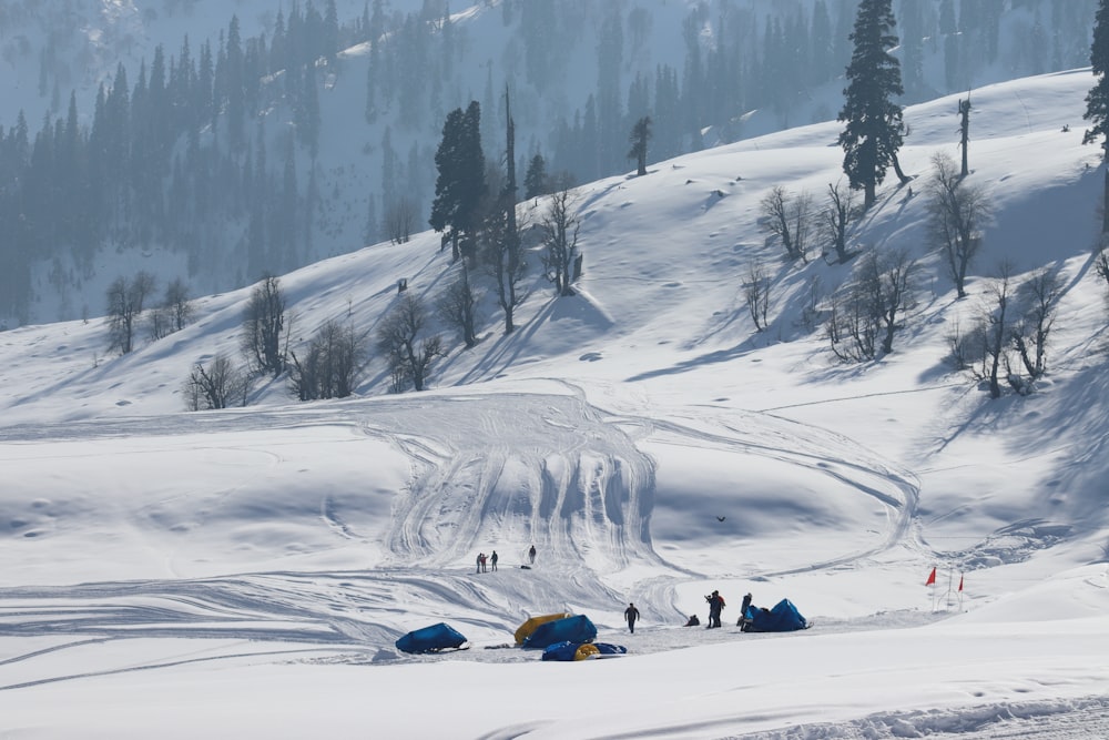 a group of people standing on top of a snow covered slope