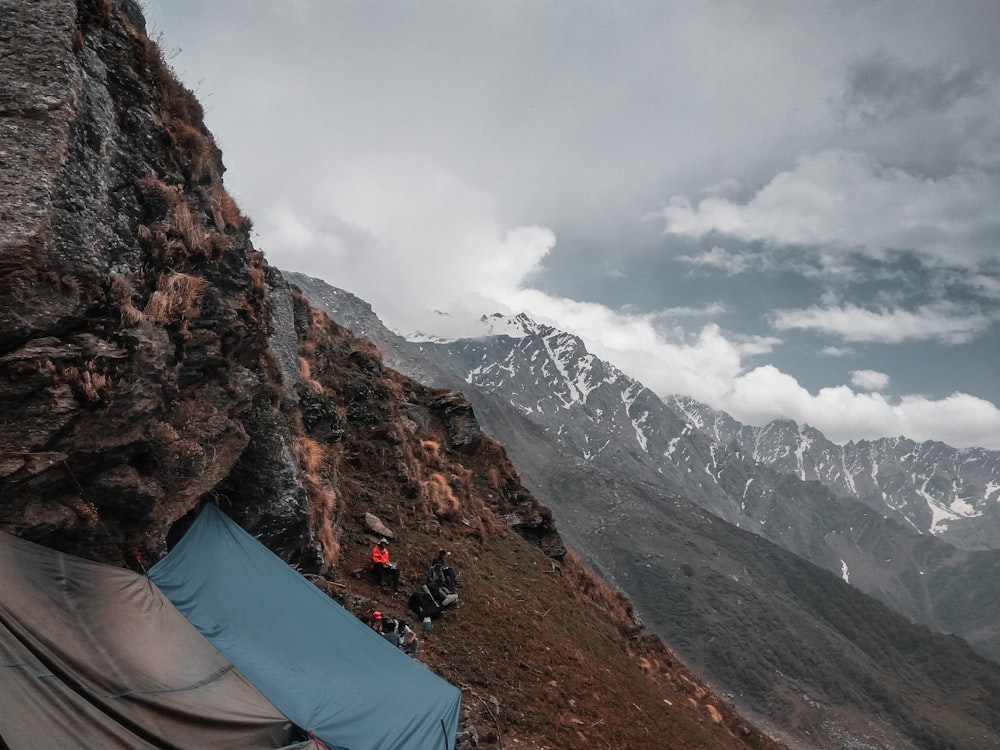 a tent pitched up on the side of a mountain