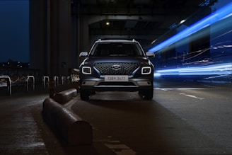 a car driving down a street at night