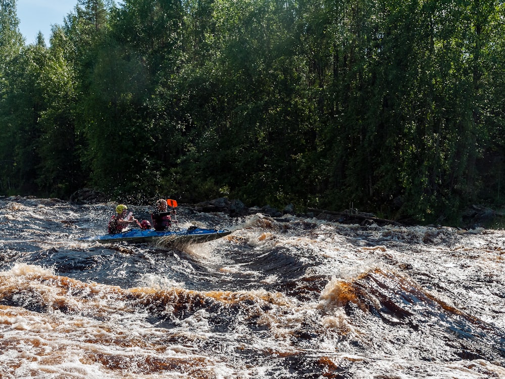 a group of people riding on top of a raft down a river