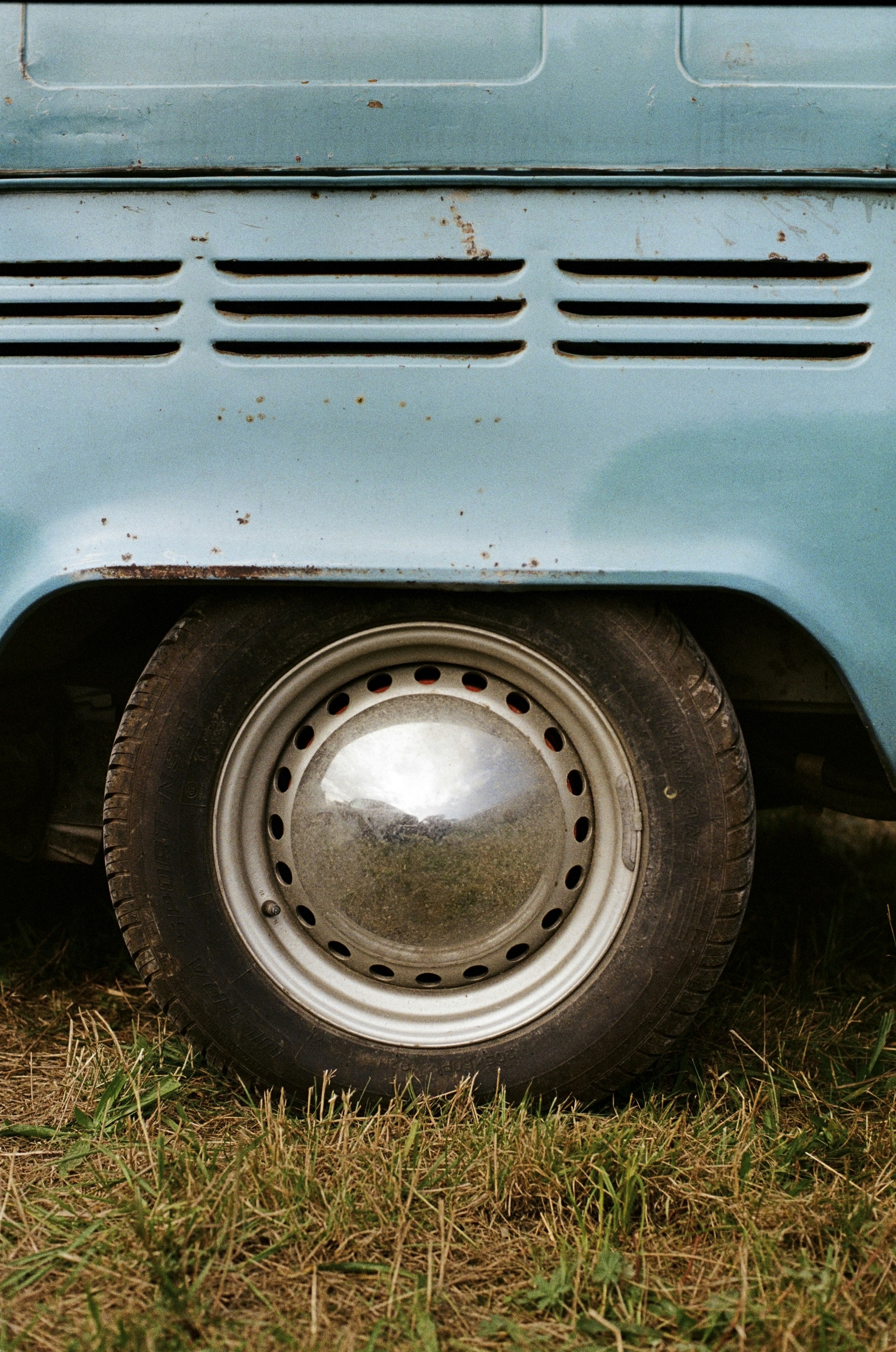 a close up of the front end of a blue truck