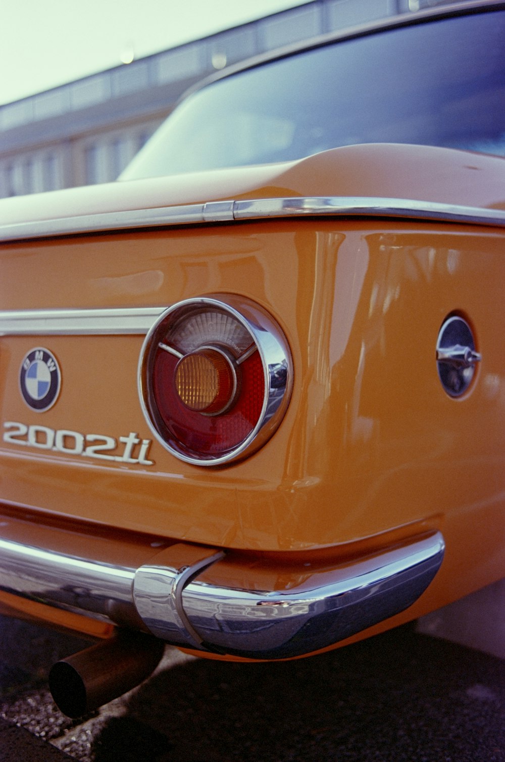 a close up of the tail end of an orange car