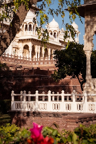 a white building with a white fence around it