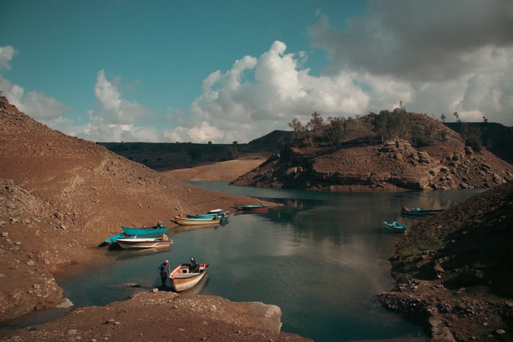 a group of boats floating on top of a lake