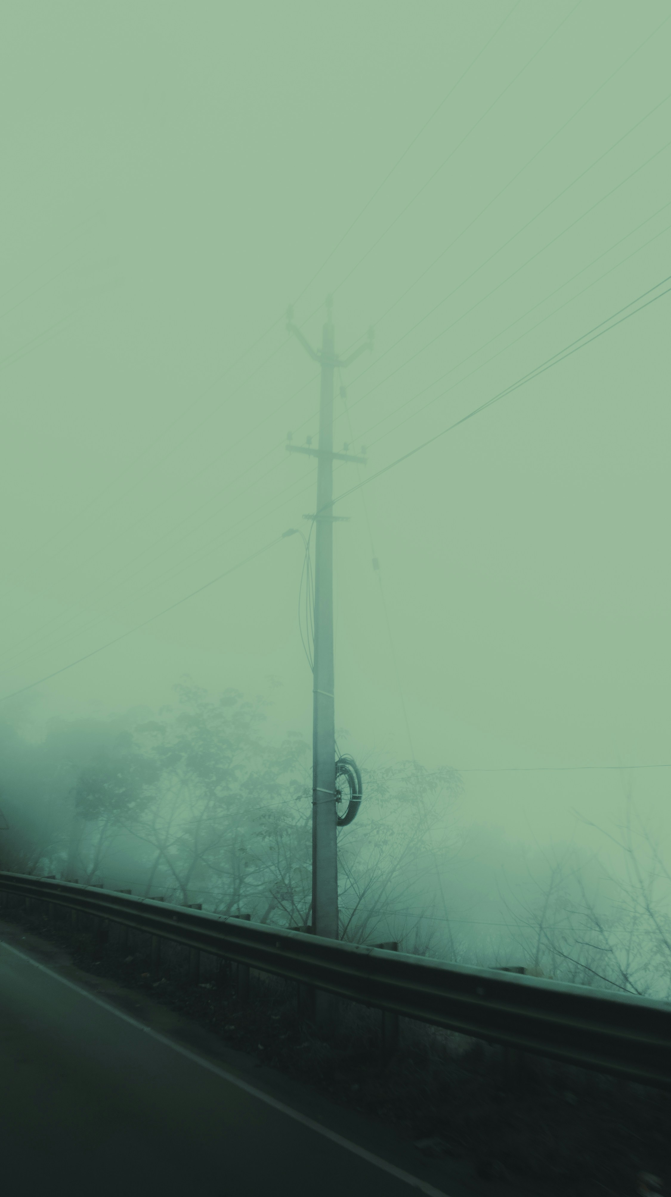 a car driving down a road next to power lines
