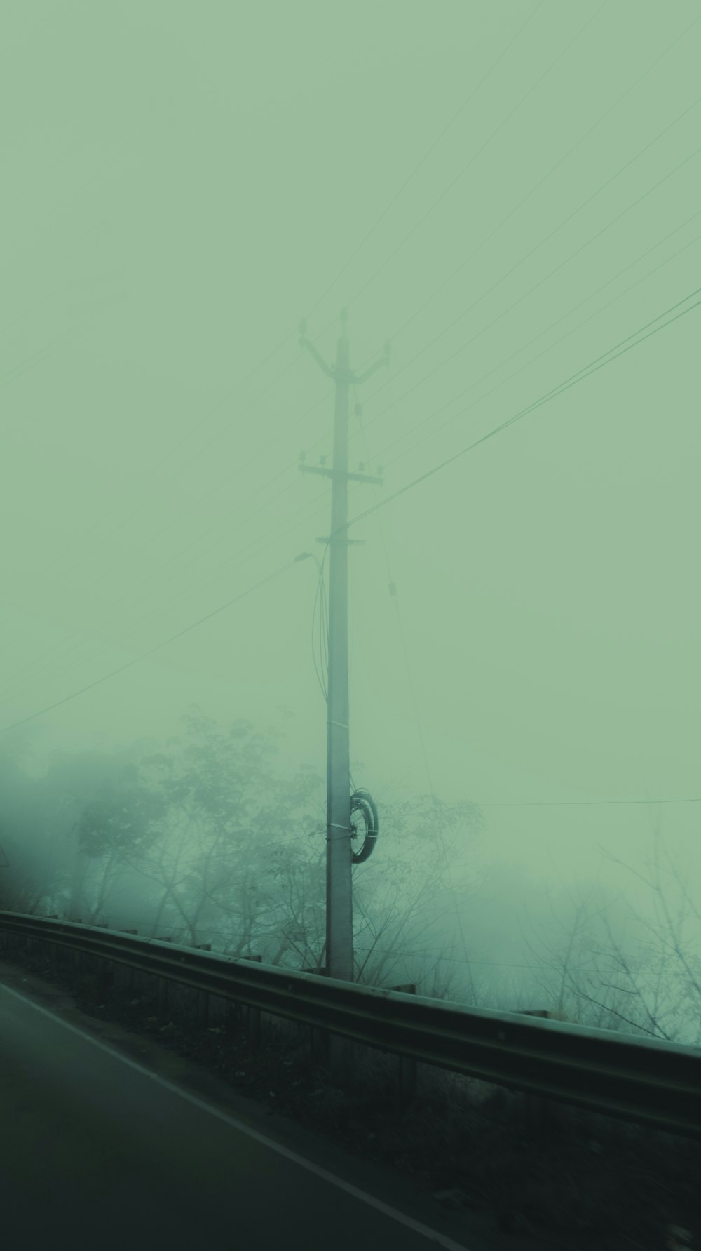 a car driving down a road next to power lines