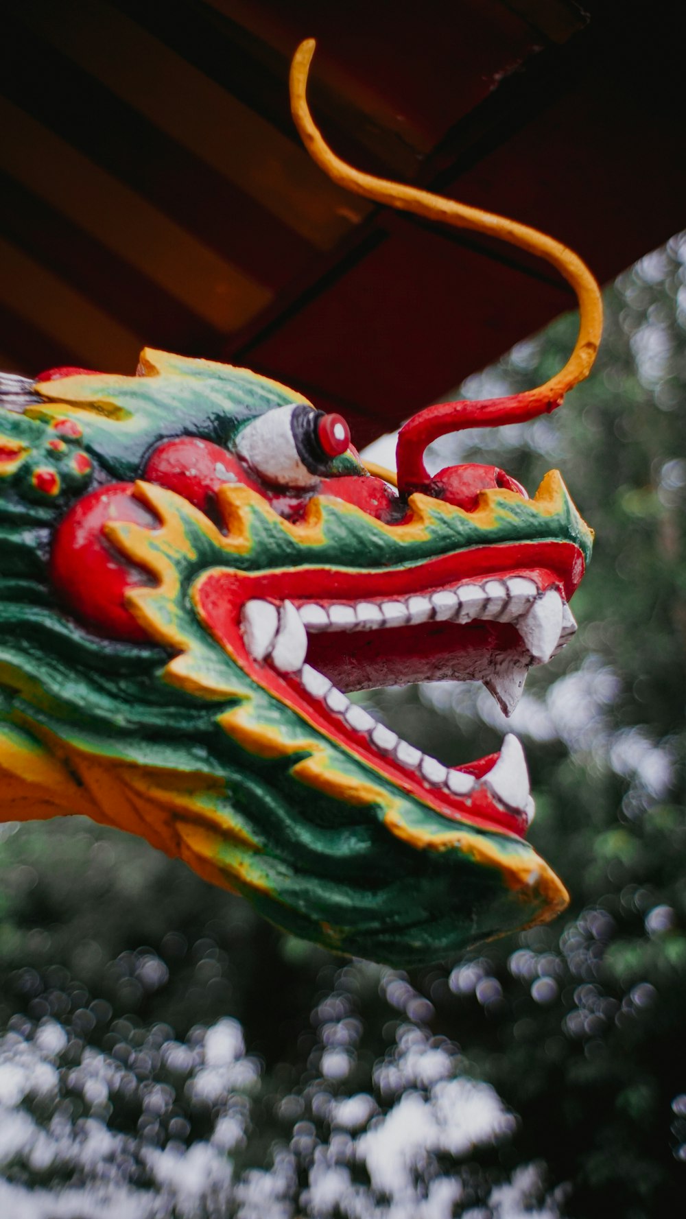 a dragon head hanging from the ceiling of a building