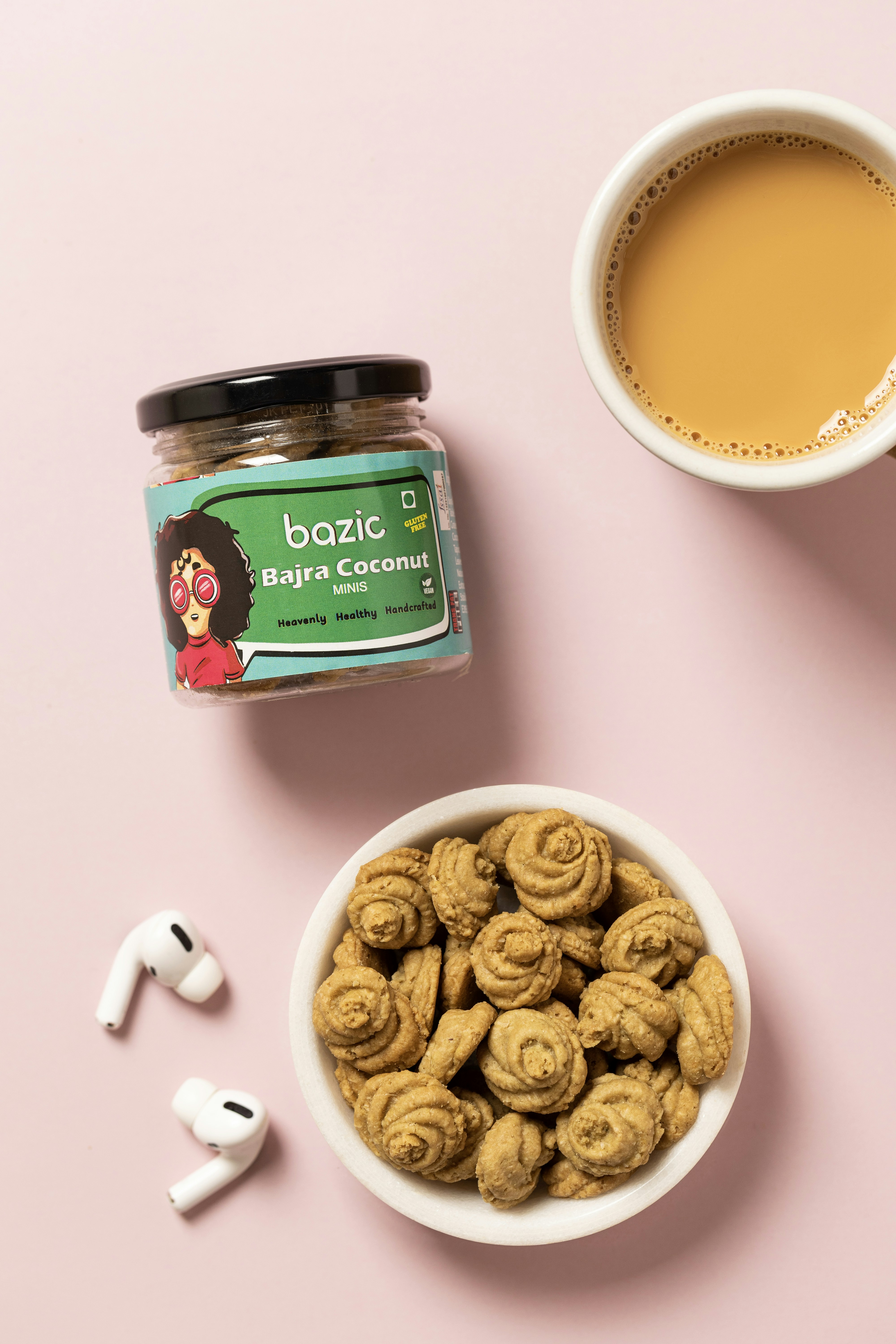 a cup of coffee next to a bowl of cookies