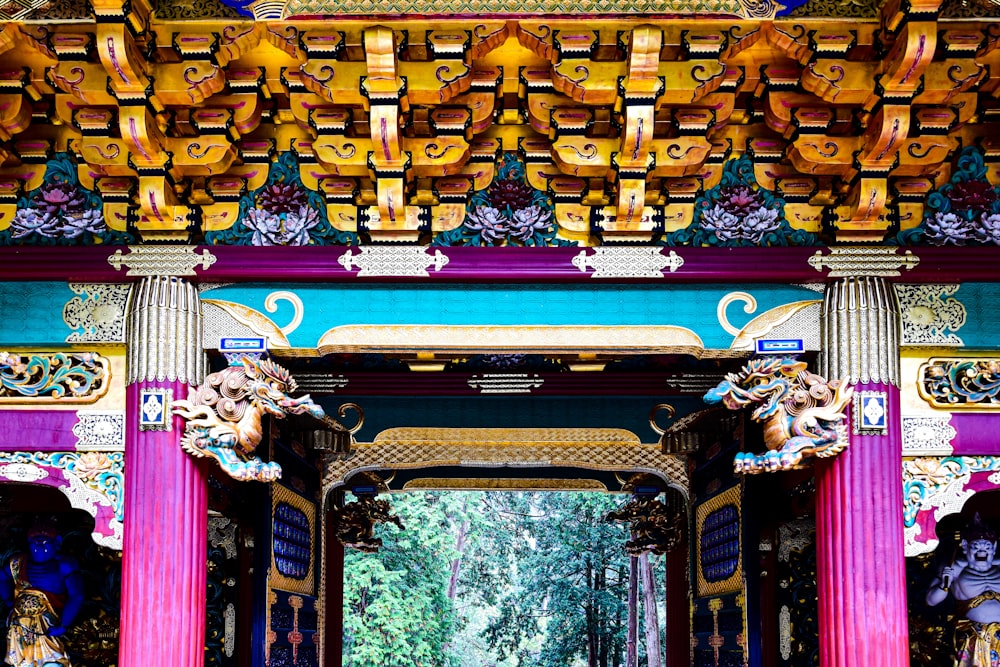 a colorful archway with statues on the sides of it