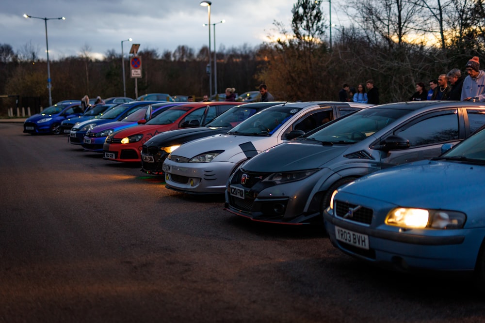 a row of parked cars sitting next to each other