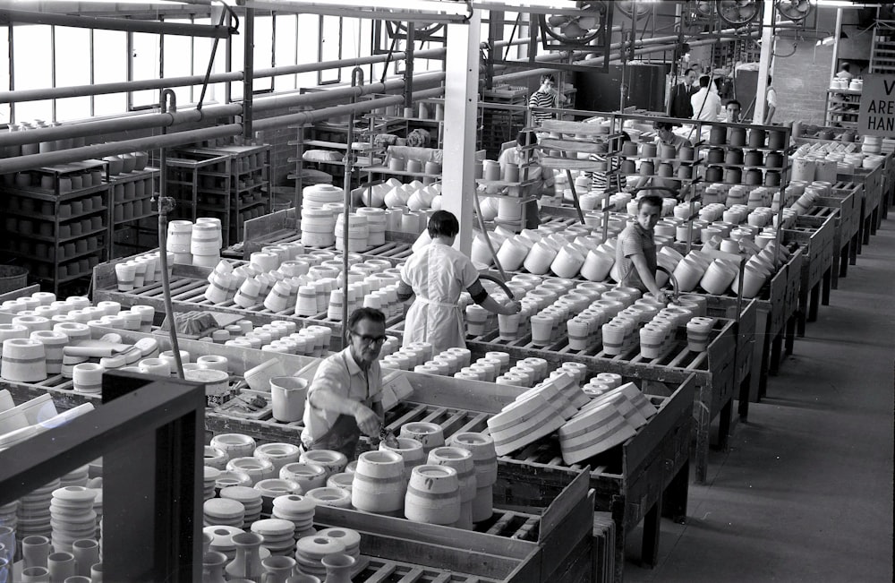 uma foto em preto e branco de trabalhadores em uma fábrica