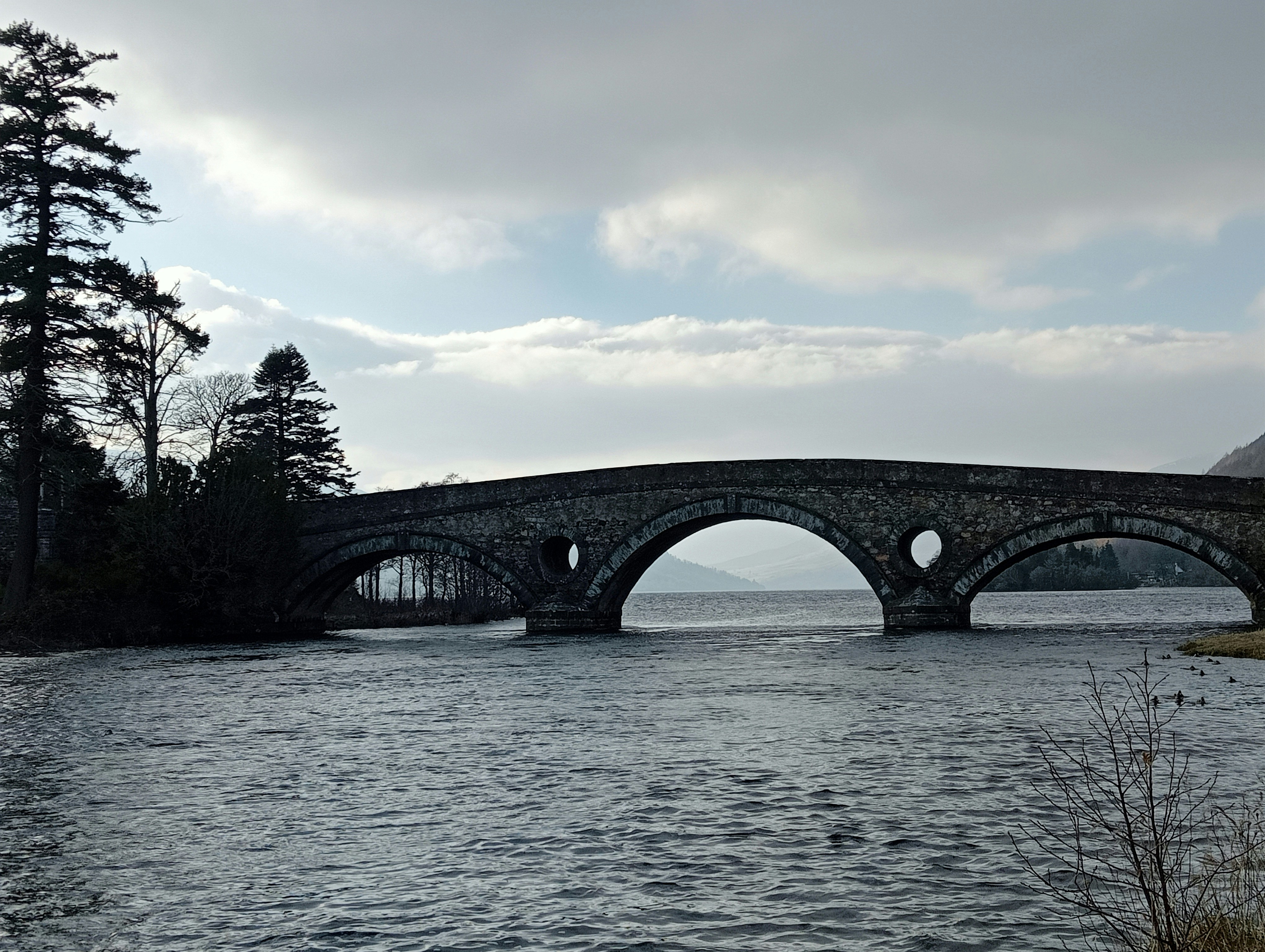 a stone bridge over a body of water