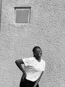 Smiling local technician standing next to a clean, well-maintained dryer vent system.