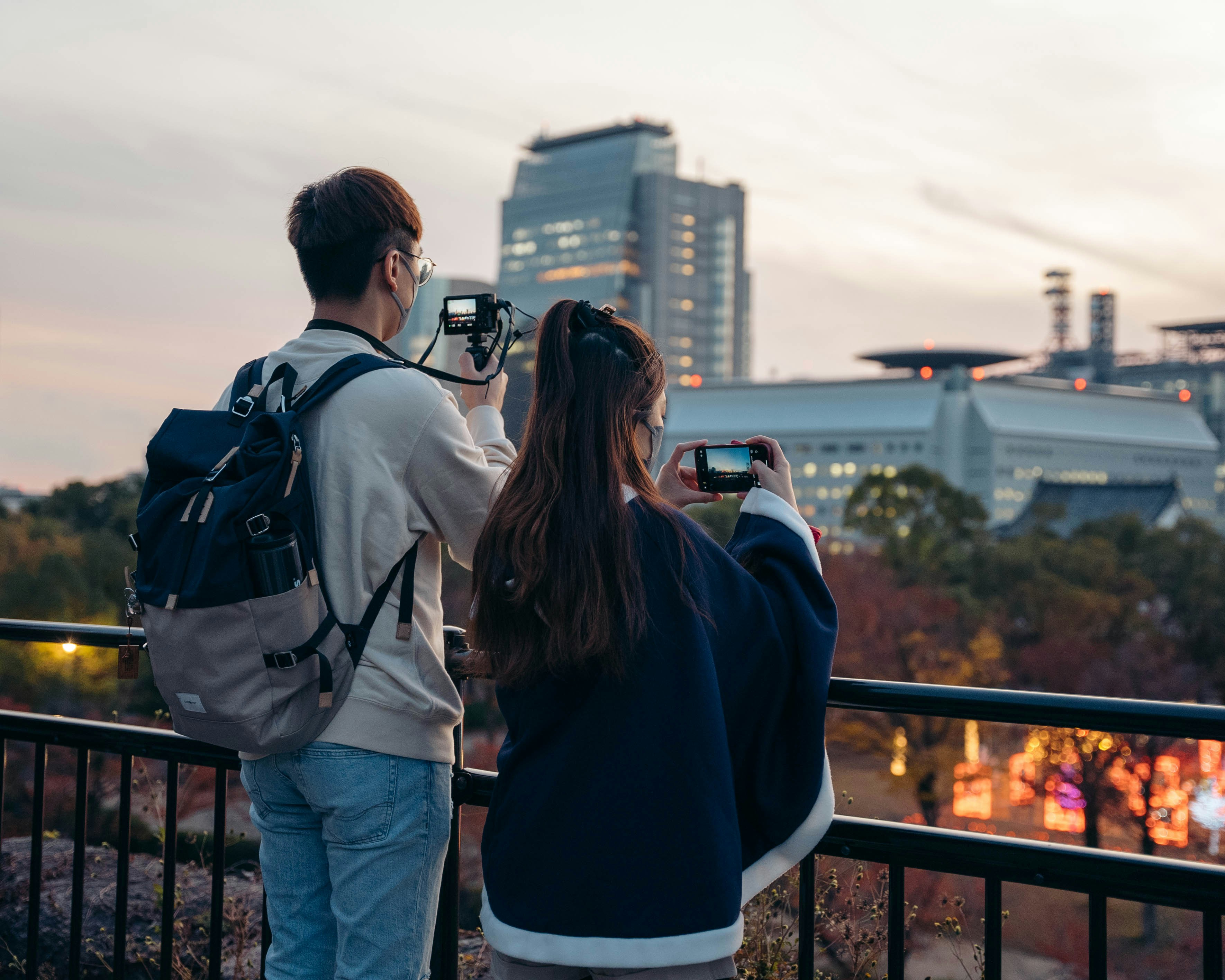 a man and a woman taking a picture of a city