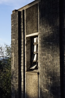 Close-up of a building wall with fresh thermal insulation panels being installed on a sunny day.