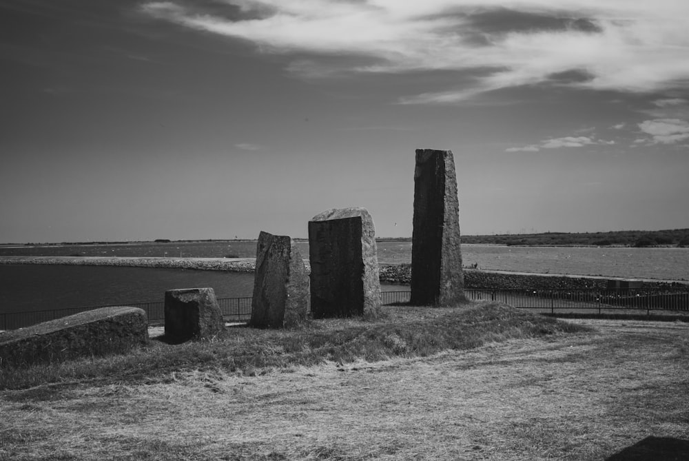 a black and white photo of some rocks by the water