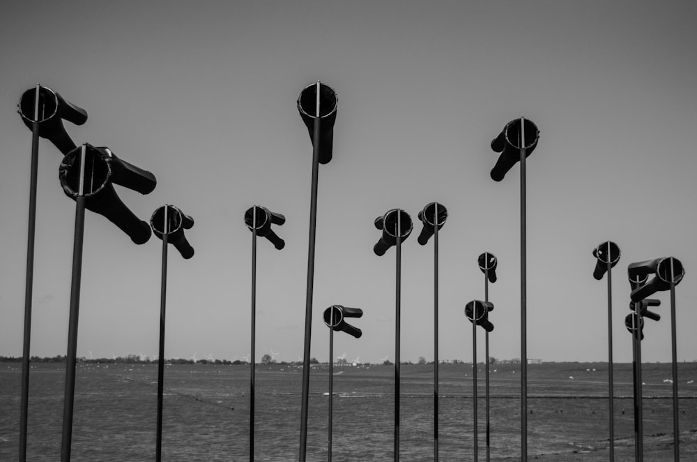 a row of parking meters sitting on top of a beach