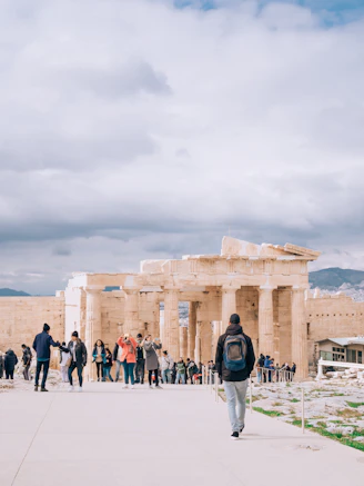 A group of travelers exploring ancient ruins with a guide.